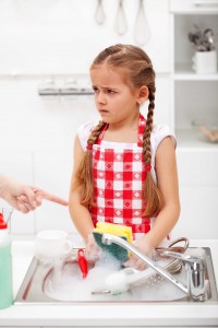 unhappy child doing chores